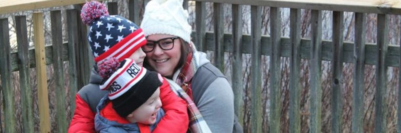 5 Life Lessons From My Son on the Autism Spectrum mother hugging two small children outdoors in winter gear