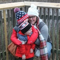 mother hugging two small children outdoors in winter gear