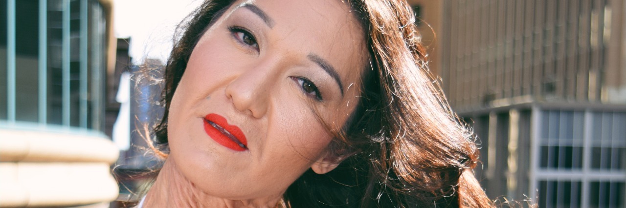 Learning Self-Love, Modeling With Ehlers-Danlos Syndrome sara geurts modeling in red top on a balcony outside