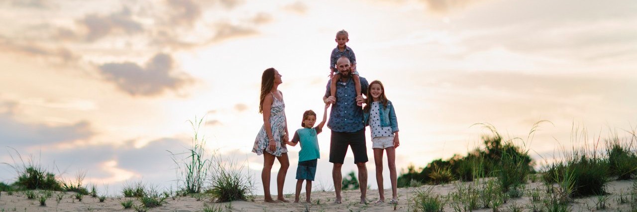 Letter to the Parents of a Child Who Just Received a SATB2 Diagnosis family poses for a photo on the beach