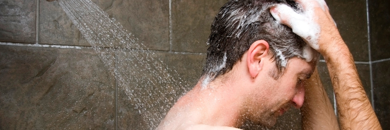 Man Showering, Water Washing Over Him