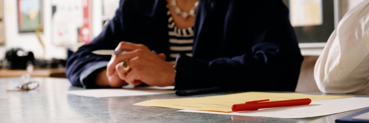 Things I Do to Prepare for My Child’s IEP Meeting woman sitting at conference room table