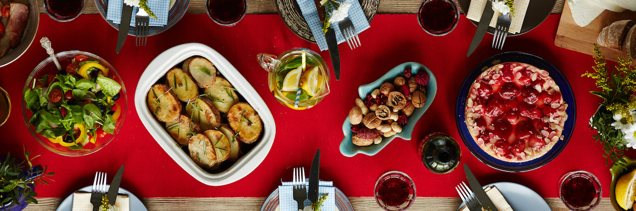 5 Tips for Surviving Christmas With an Eating Disorder Baked potatoes, strawberry cake, homemade lemonade, vegetable salad, nuts and tableware prepared for dinner