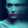 Blue toned beauty portrait of young Caucasian woman with wet hair with a motion blur effect