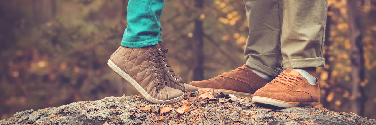 Couple Man and Woman Feet in Love Romantic Outdoor with Autumn season nature on background Fashion trendy style
