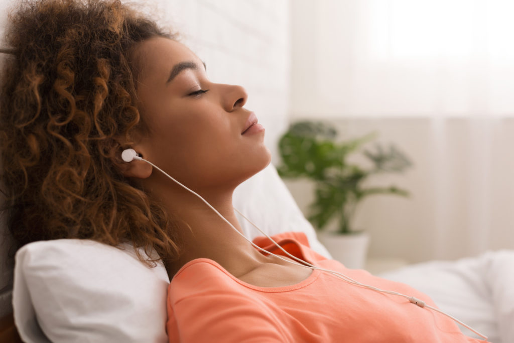 Image of a woman relaxing while listening to music