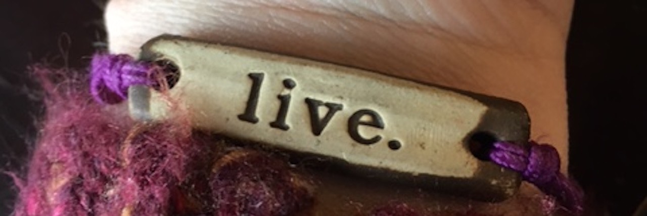 Why I Don't Make New Year's Resolutions With Dysautonomia bracelet that says 'live'