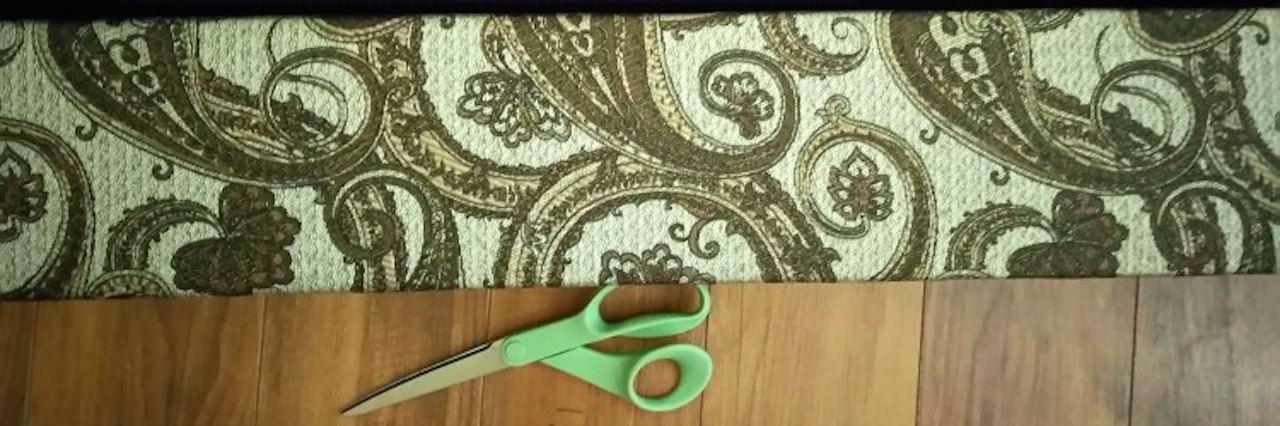 fabric and scissors lying on a wood floor