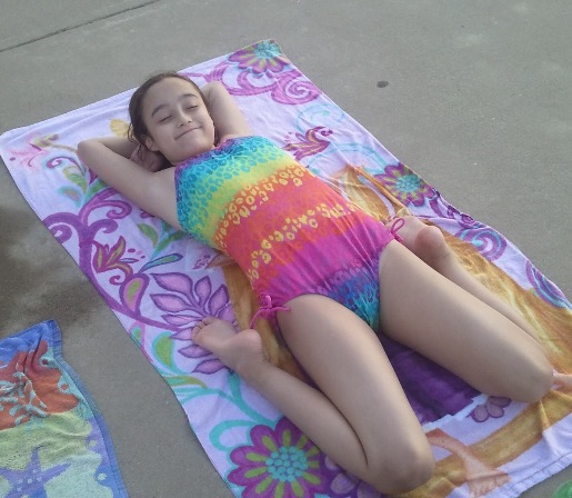 girl lying on towel at beach