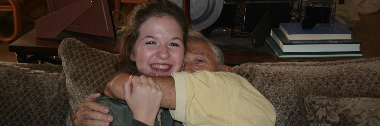 young woman hugging her grandfather