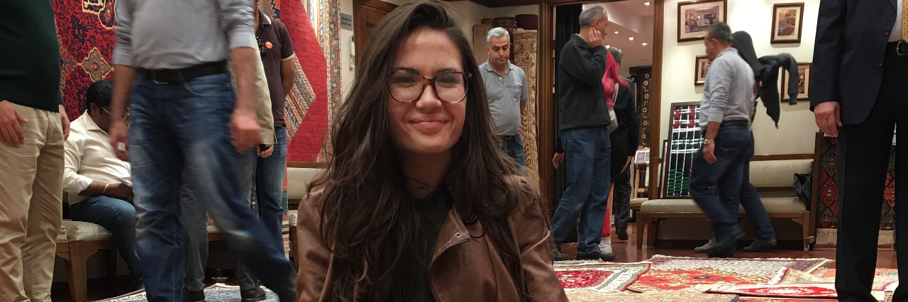 When Airport Security Flagged Me for My Limb Difference Kelsey sitting on a mat while stuck in Turkey.