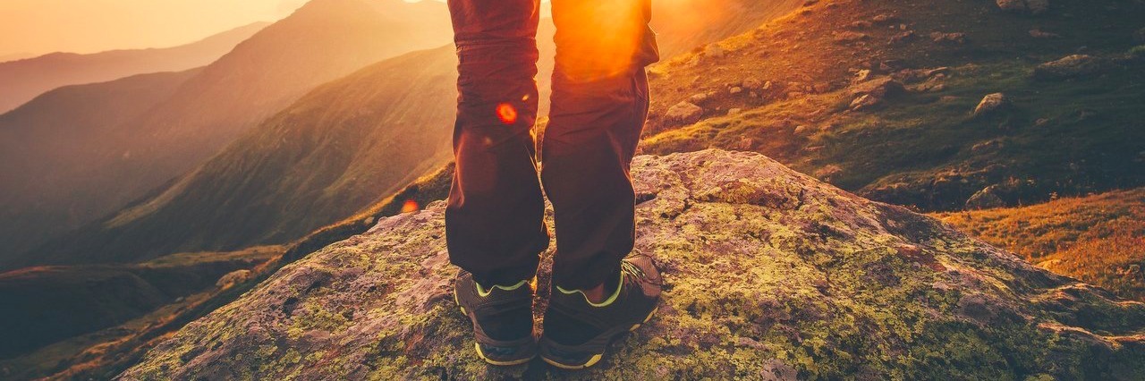 My Fibromyalgia Diagnosis Creates Need to Have New Year’s Resolutions man hiking in the mountains and watching the sunset