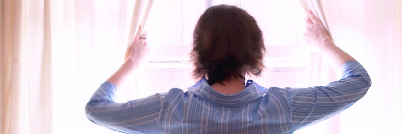 Finding Community and Peace After an Ehlers-Danlos Syndrome Diagnosis woman looking out window