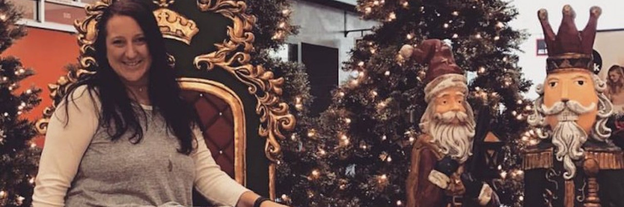 3 Things I Want Family to Know About My Anxiety This Christmas A woman seated in front of a Christmas tree