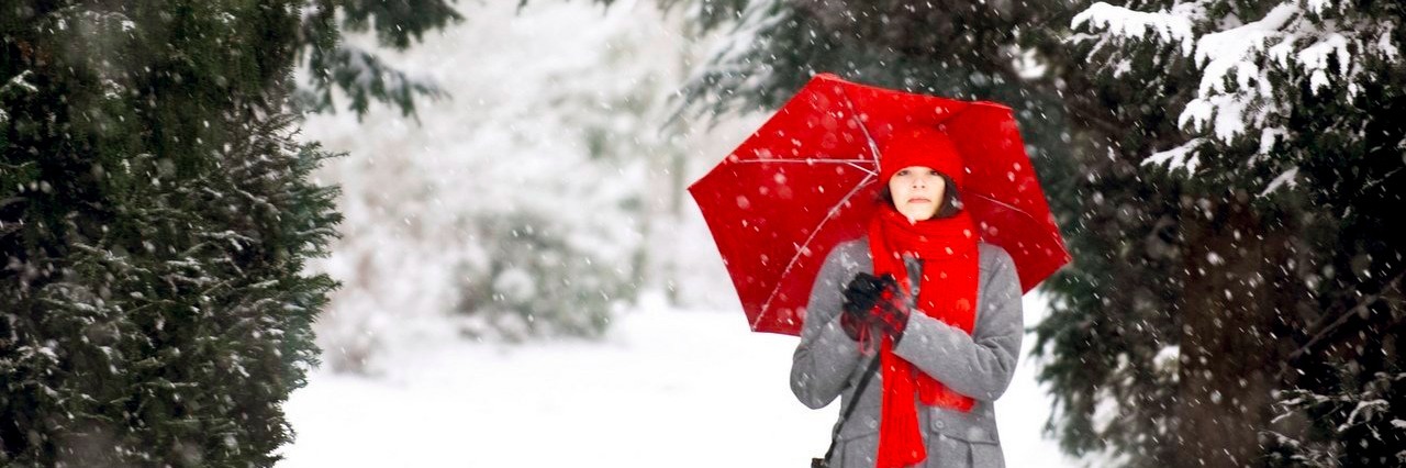 Woman With a Chronic Illness Shares Her Grown-Up Christmas List woman with a red umbrella in the snow