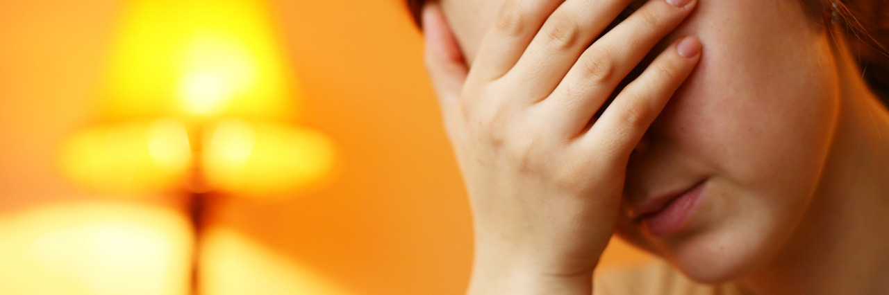 Trying to Understand a Person With Bipolar Disorder An image of a woman with her hand over her face