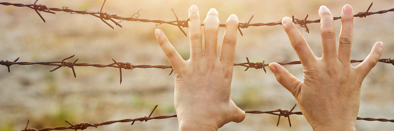 Thoughts of a Mind Struggling With Depression and Anxiety Woman hands hold the rusty sharp bare wire with hope longing for freedom among flying birds, Human rights concept