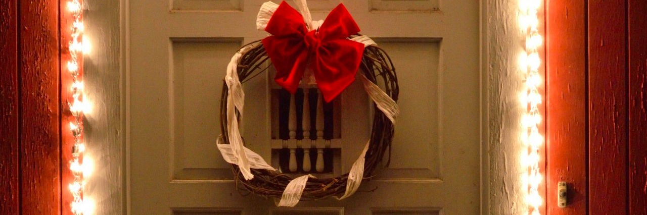 Tips for Visitors During My First Christmas With a Chronic Illness Christmas lights and wreath on front door at night