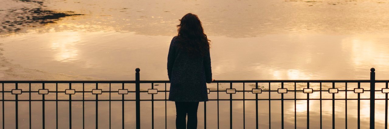 Please Don’t Tell Young Women They’ll Understand When They’re a Mom woman looking at the sunset during winter