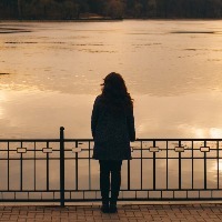 woman looking at the sunset during winter