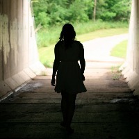 woman walking out of tunnel