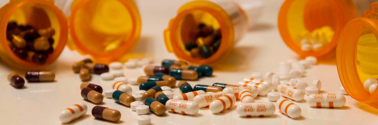 Mental Illness: Living With an Illness Other People Cannot See pill bottles spilled on a table