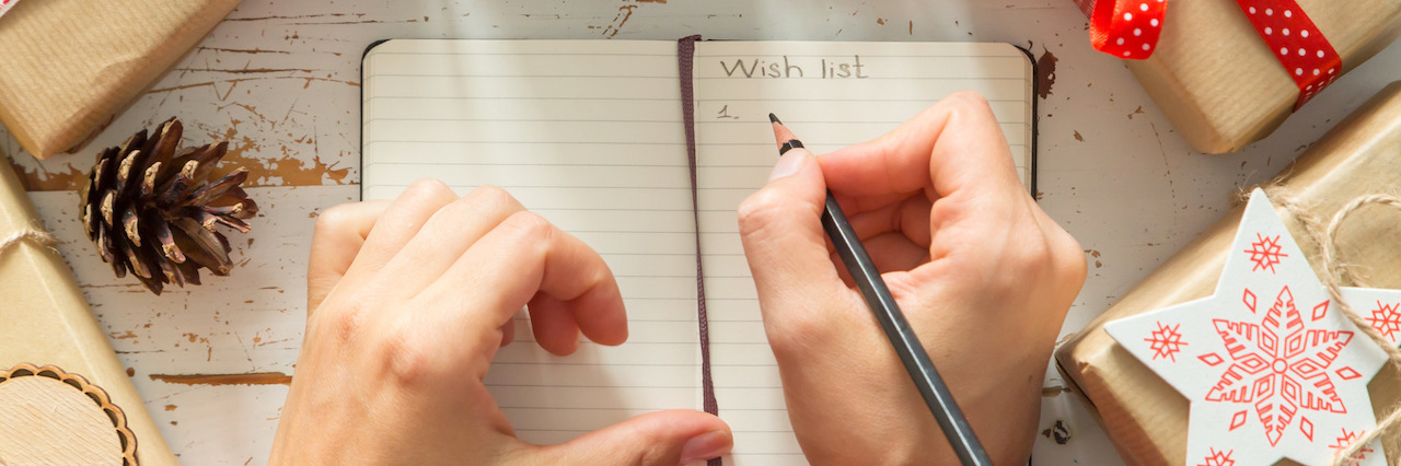 8 Things a Person With Mental Illness Wants for Christmas Making list of presents on wood background, copy space