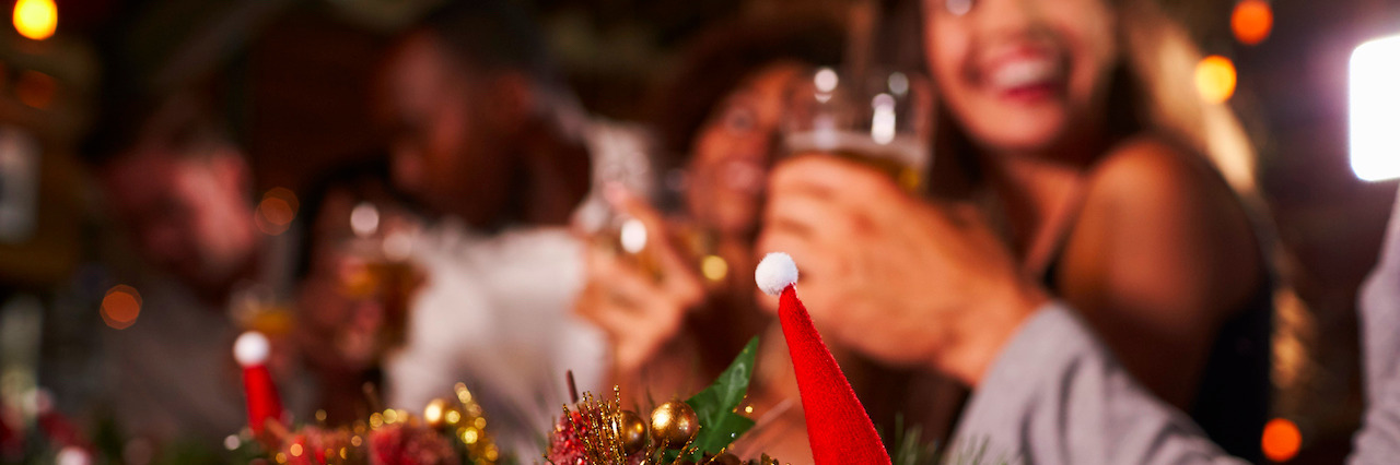 What Social Anxiety Is Like at Christmastime Christmas party at a bar, focus on foreground decorations