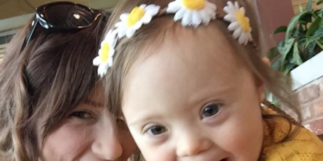 Mom Becomes Special Needs Photographer After Her Daughter Is Born With Down Syndrome photographer and kid with down syndrome