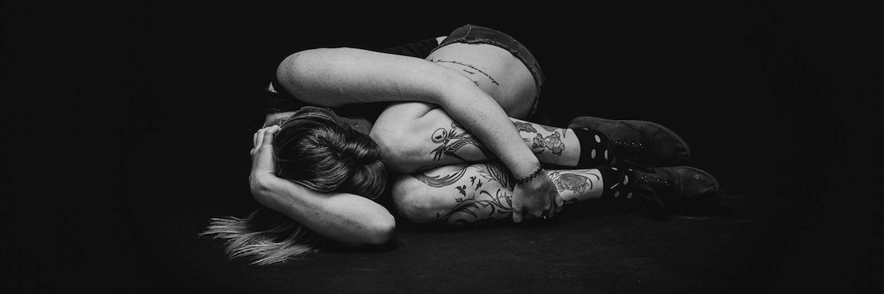 Miss. Poison: Borderline Personality Disorder Photo Series A woman curled up in a ball on the floor