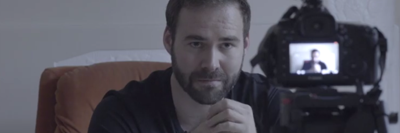 Learning How to Love Yourself With Bipolar Disorder a man looking into a camera