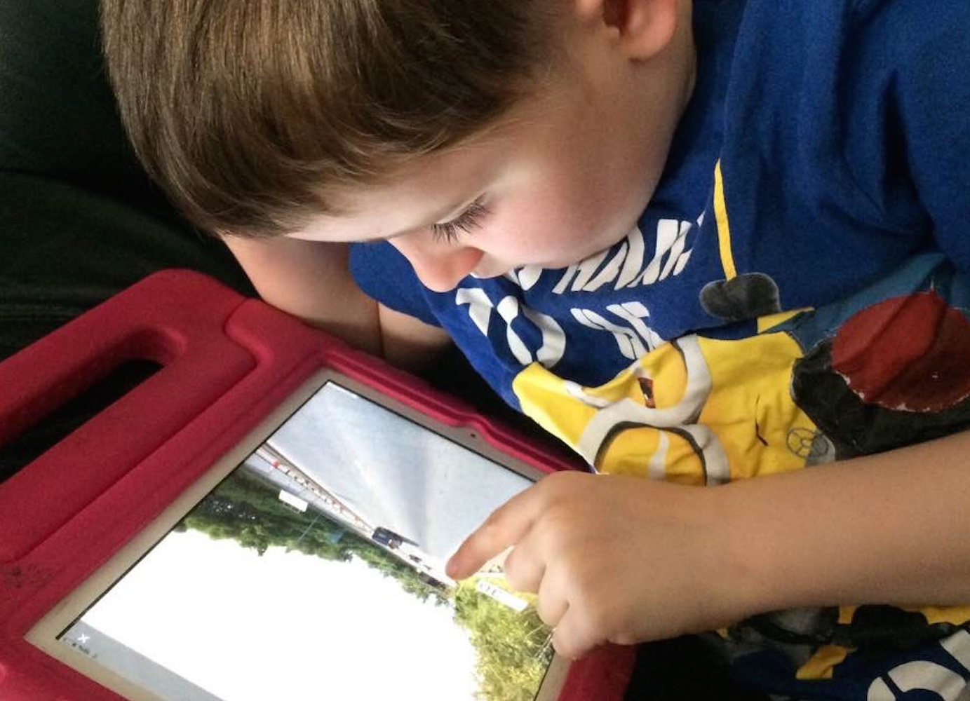 Boy using Google Street Maps view on iPad