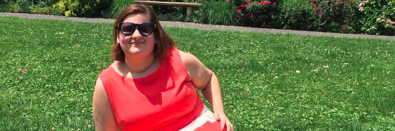 Living With Retinoblastoma and Side Effects of Treatment woman in red and white dress sitting on grass lawn