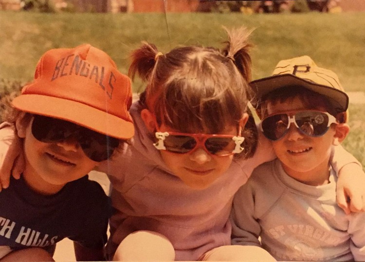 An old photo of the author and her two younger siblings wearing sunglasses