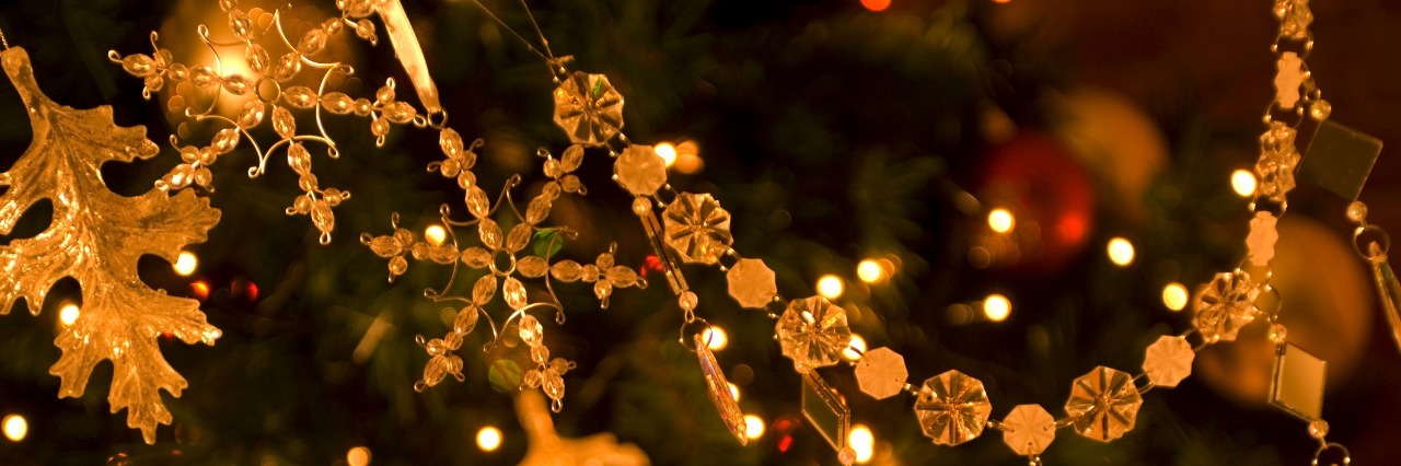 close up of golden ornaments on a christmas tree