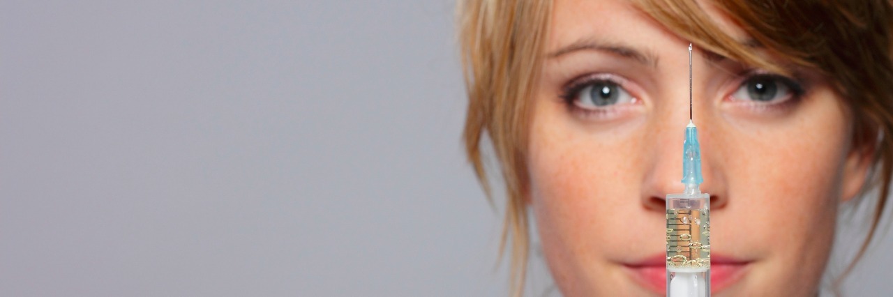 Rheumatoid Arthritis and Learning to Give Myself Weekly Injections woman with an injection