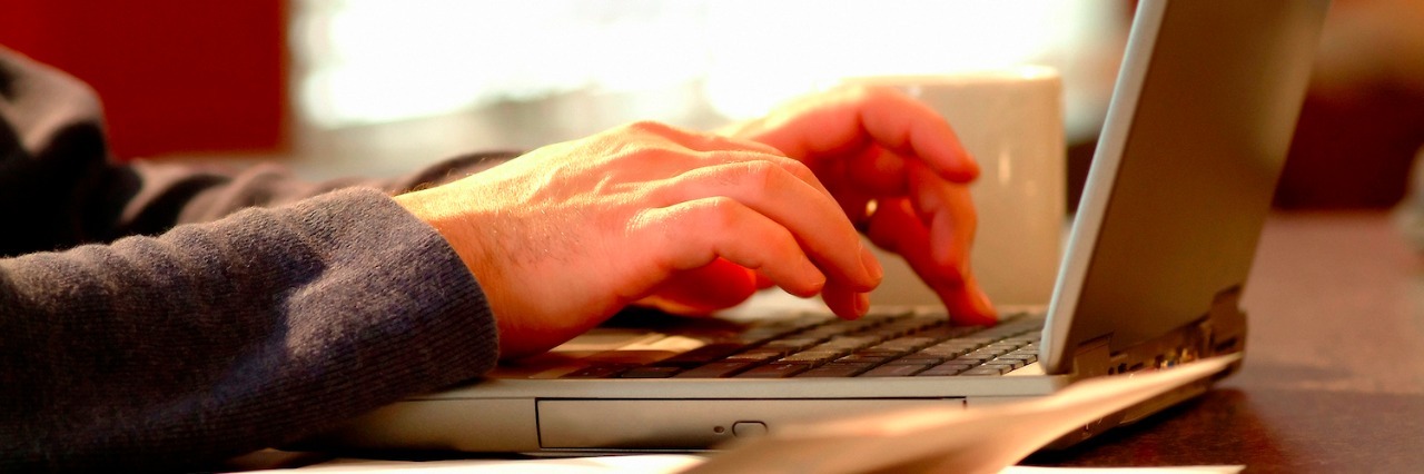 Man using laptop in home office.