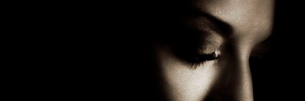 Things That Help Calm Me During a Panic Attack Profile of woman with eyes closed in a dark space