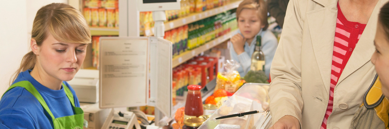 Family at the grocery store checkout.