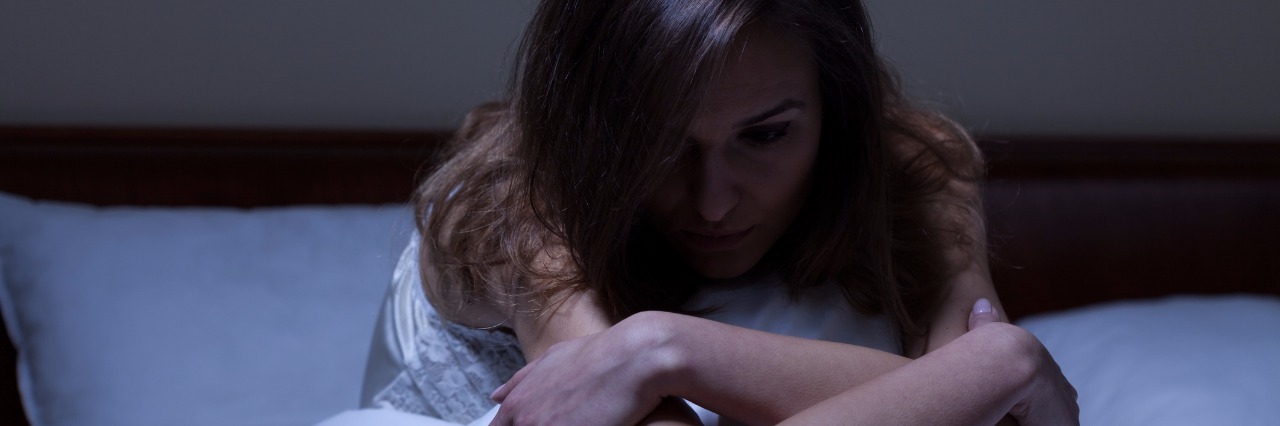 What to Remember on Hard Nights With Chronic Pain woman siting up in bed at night