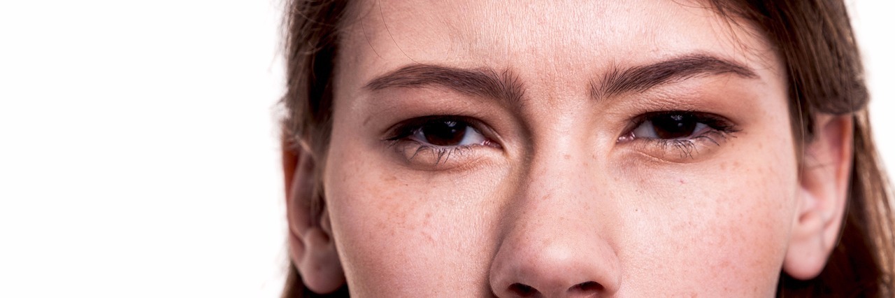 10 Things Not to Say to Someone With Depression A woman signaling for someone to be quiet with her finger over her pursed lips