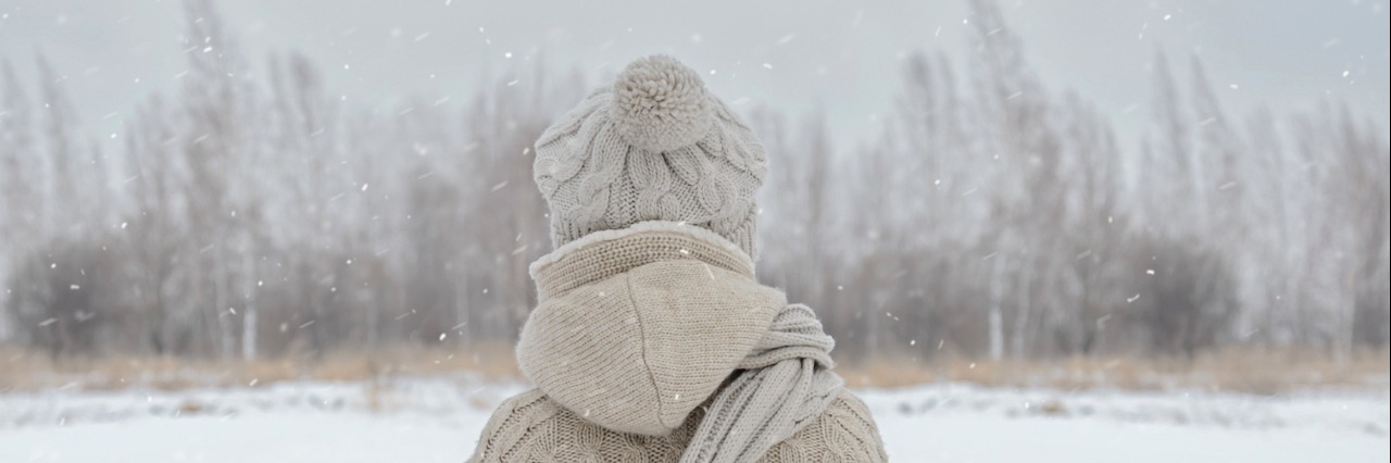 Grief and Pain at Christmas After the Loss of My Son Woman facing woods in the winter as it snows