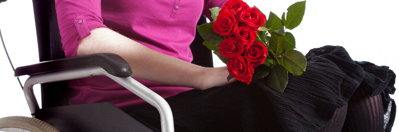 Woman in a wheelchair with roses.