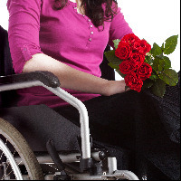 Woman in a wheelchair with roses.