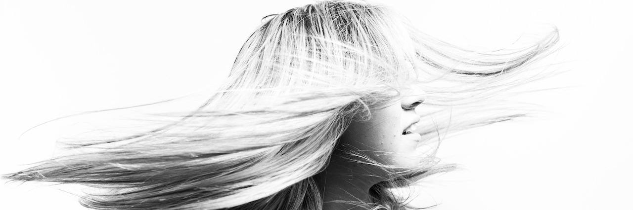 New Year's Resolutions From a Person With Mental Illness a black and white illustration of a woman flipping her hair