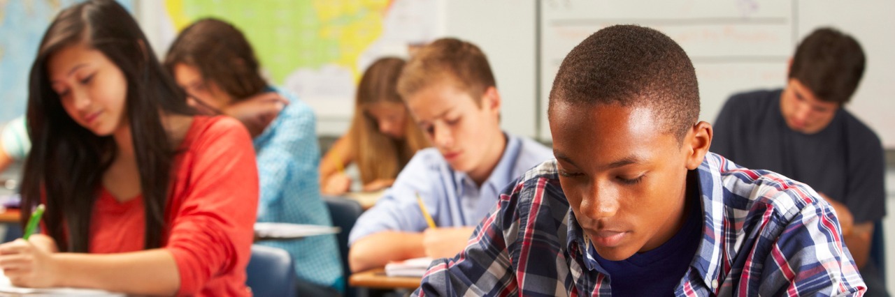 What It's Like to Have Social Anxiety in the Classroom High school students sitting in a classroom, writing