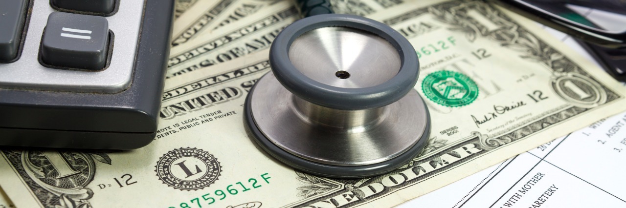 The Financial Cost of Having a Chronic Disease Pen stethoscope glasses calculator and dollar on blank Patient information