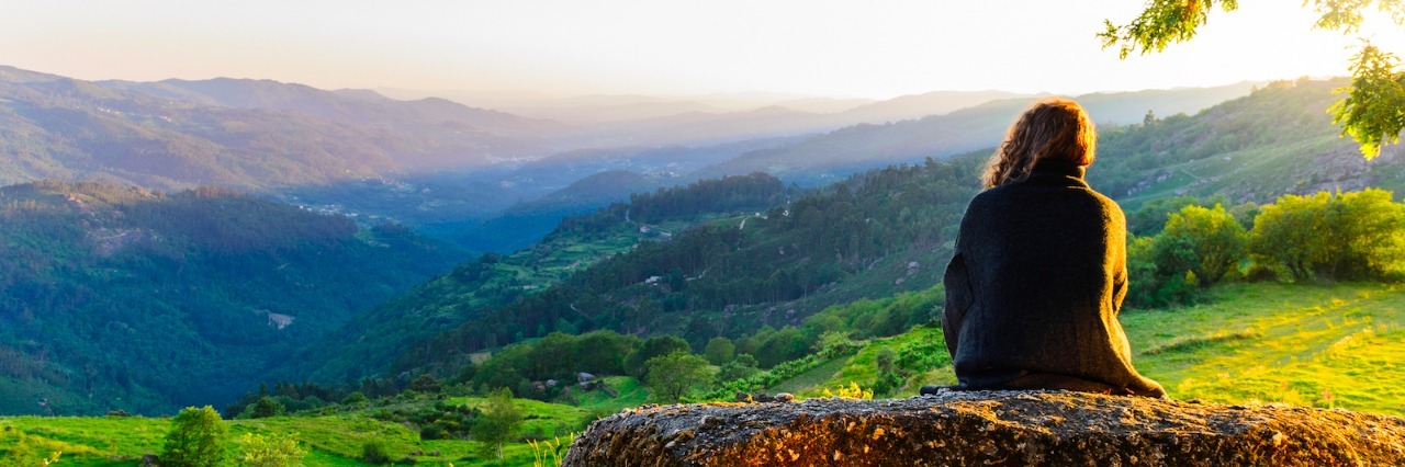 Ankylosing Spondylitis: How My Perspective Changed After My Diagnosis Woman sitting, looking at mountain landscape