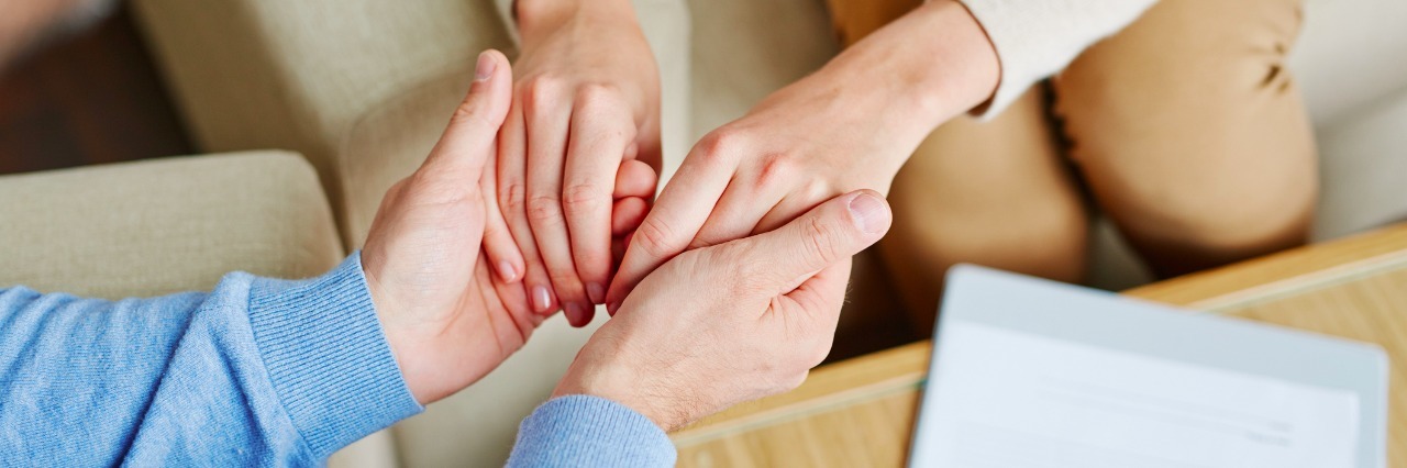 When Your Therapist Is on Vacation or Unavailable close-up of therapist holding patient hands