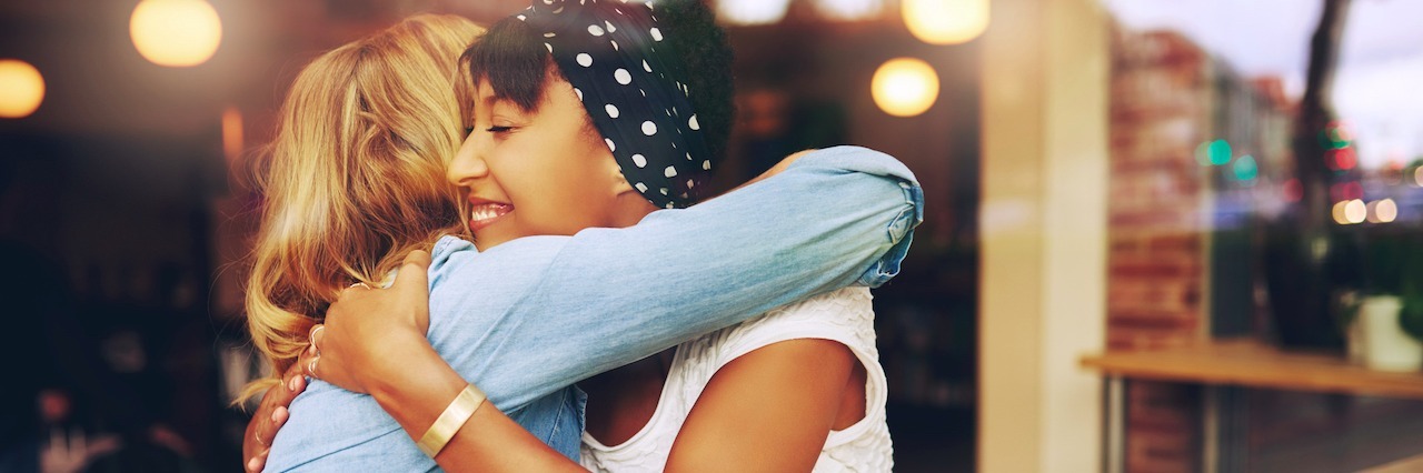 8 Things to Know About Your Friend With Anxiety and Depression two friends hugging while getting coffee